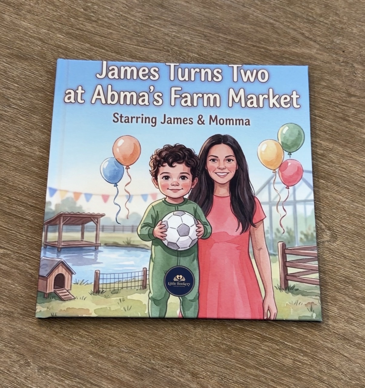 Printed Little Bookery hardcover titled James Turns Two at Abma's Farm Market, starring James and Momma